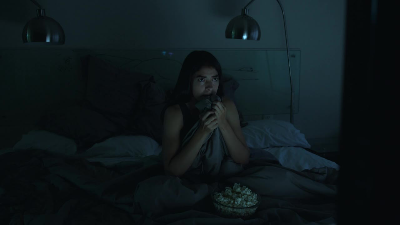 Stock Video Girl Watching A Horror Movie In Her Bedroom With The Live Wallpaper For PC