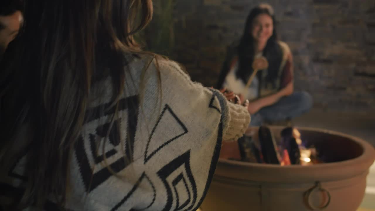 Stock Video Girl Warming Her Hands At A Campfire With Her Friends Live Wallpaper For PC