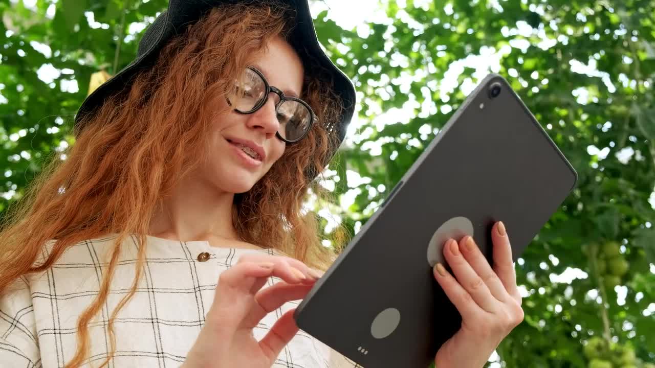 Stock Video Girl Using A Big Tablet In A Garden Live Wallpaper For PC