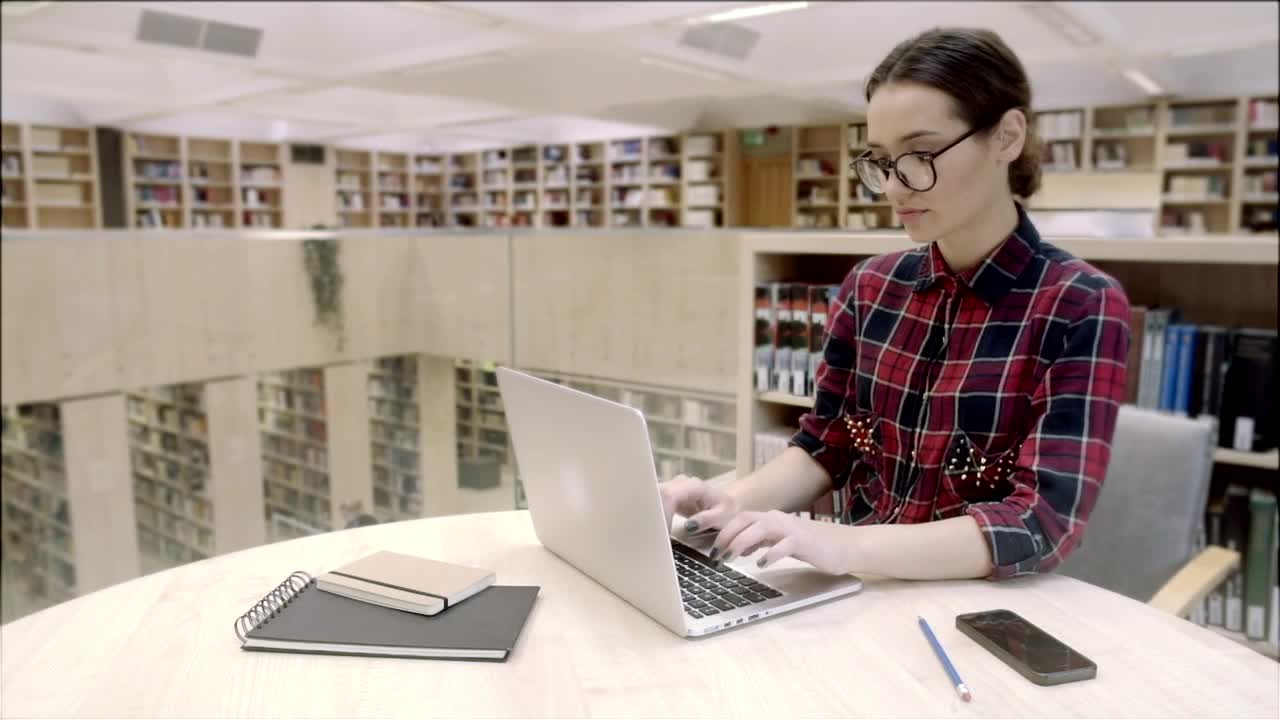 Stock Video Girl Typing On Laptop Computer In The Library Live Wallpaper For PC