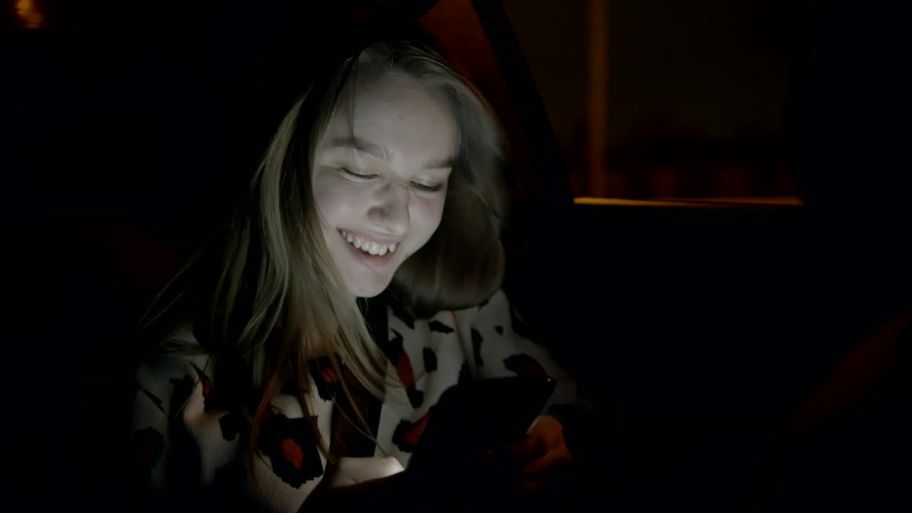 Stock Video Girl Texting In The Back Seat Of A Car Live Wallpaper For PC