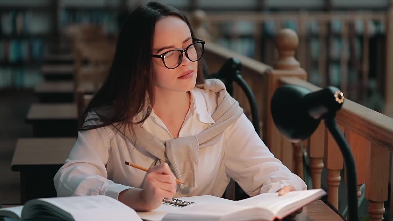 Stock Video Girl Studies Late In Library To Prepare For Exam Live Wallpaper For PC