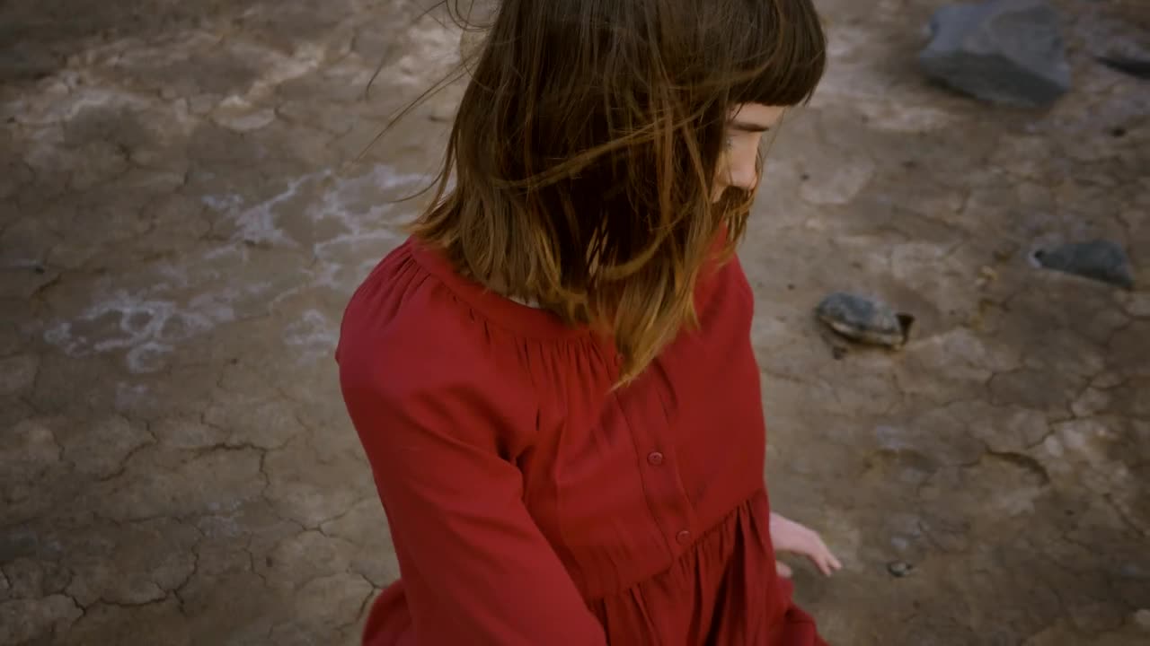 Stock Video Girl Stretching With Her Body Sitting In A Desert Live Wallpaper For PC