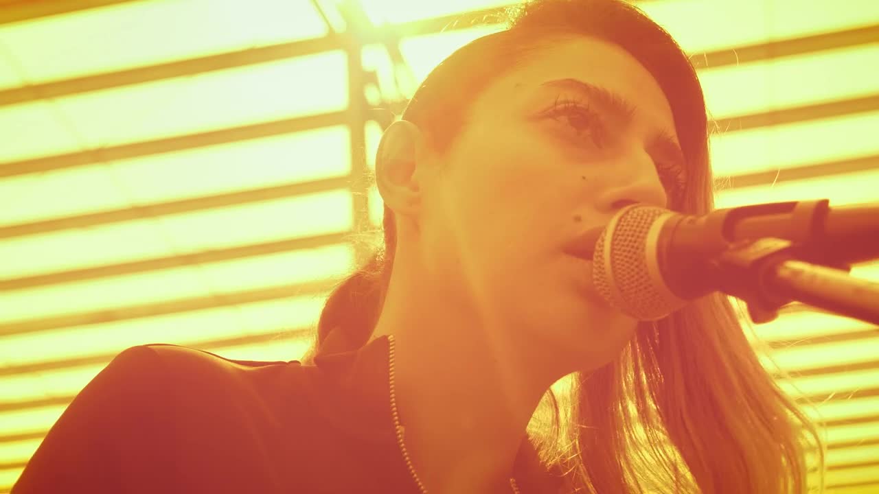 Stock Video Girl Singing Into A Microphone And Playing The Guitar Live Wallpaper For PC