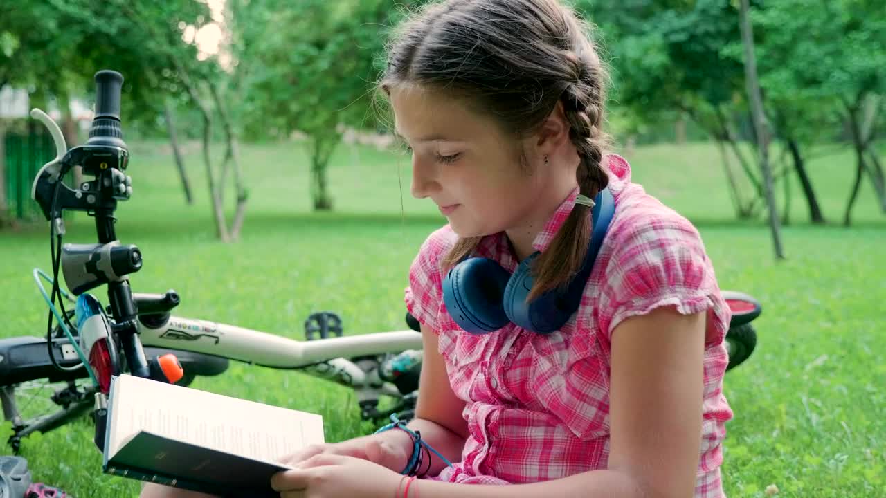 Stock Video Girl Reading Outside Next To Her Bike Live Wallpaper For PC