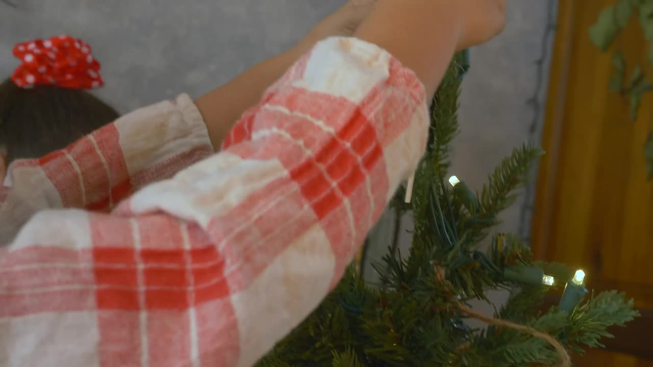 Stock Video Girl Putting The Star Of A Christmas Tree Live Wallpaper For PC