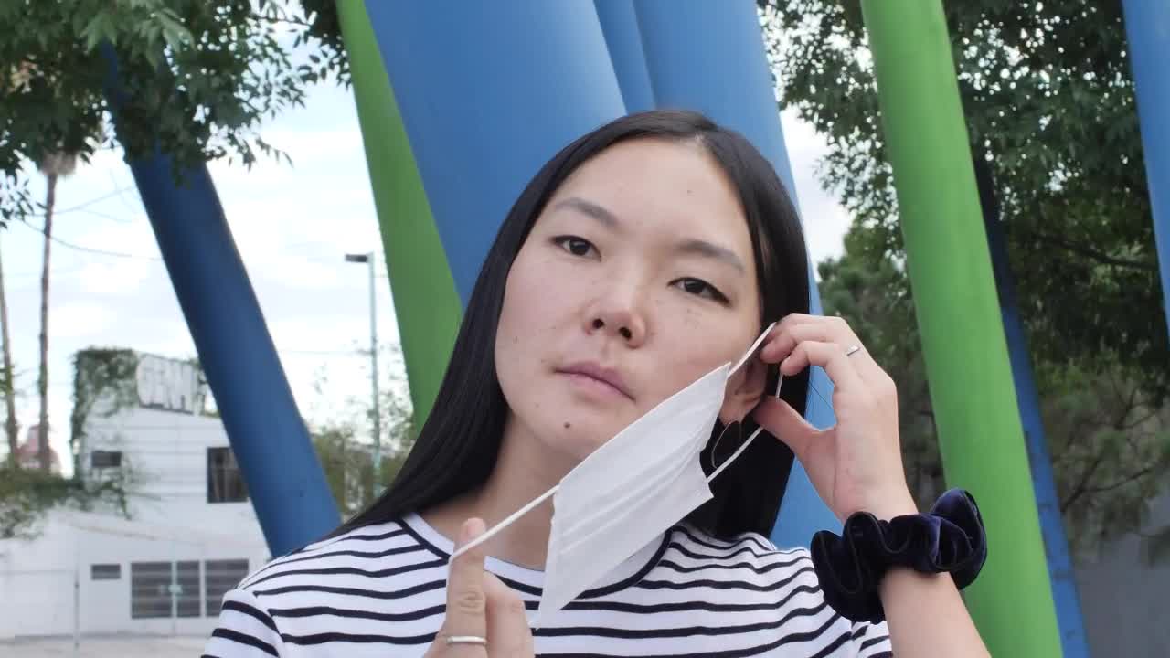 Stock Video Girl Putting On A Mask In The Middle Of The Live Wallpaper For PC