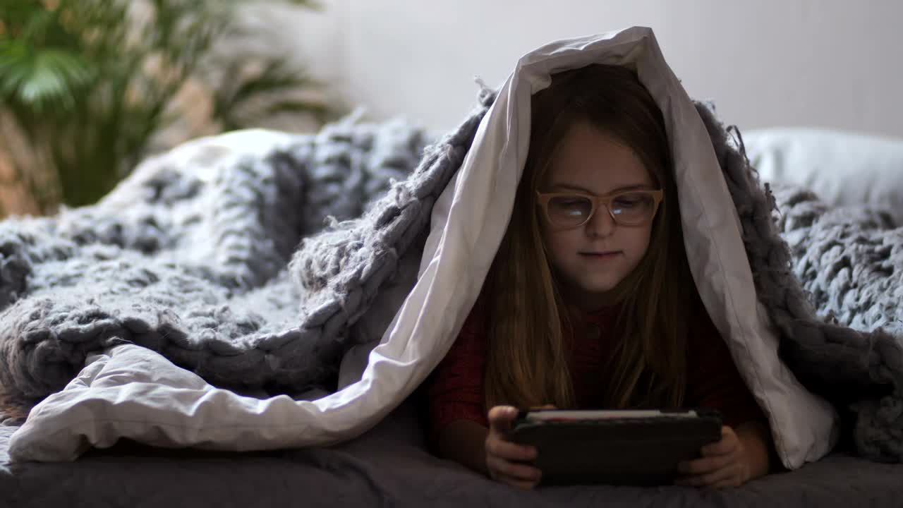 Stock Video Girl Playing With A Tablet Under A Blanket Live Wallpaper For PC