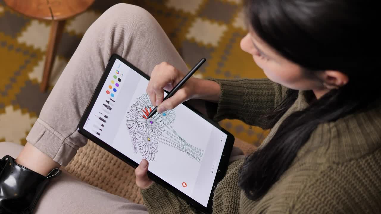 Stock Video Girl On A Sofa Coloring Flowers On A Tablet Live Wallpaper For PC