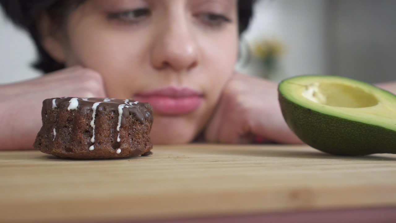Stock Video Girl Making Difficult Choice Between Bad And Good Food Live Wallpaper For PC