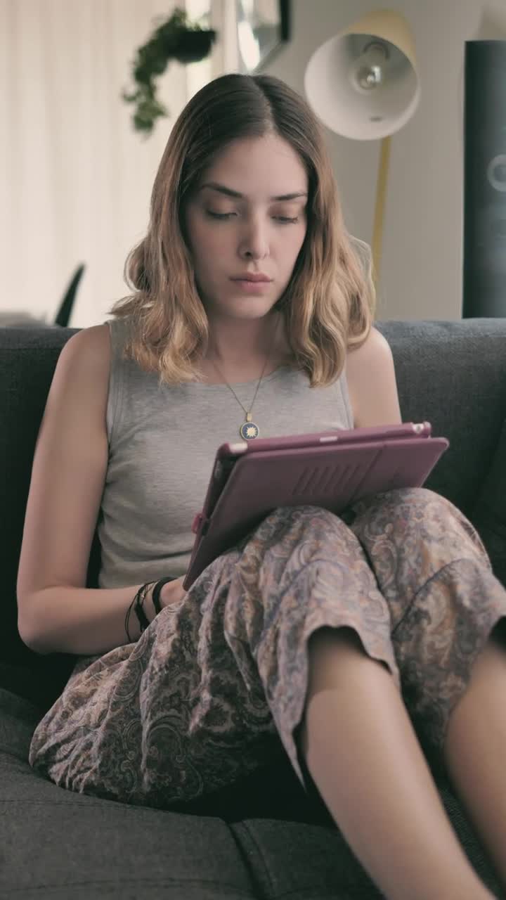 Stock Video Girl Lying In An Armchair Using An Ipad Live Wallpaper For PC