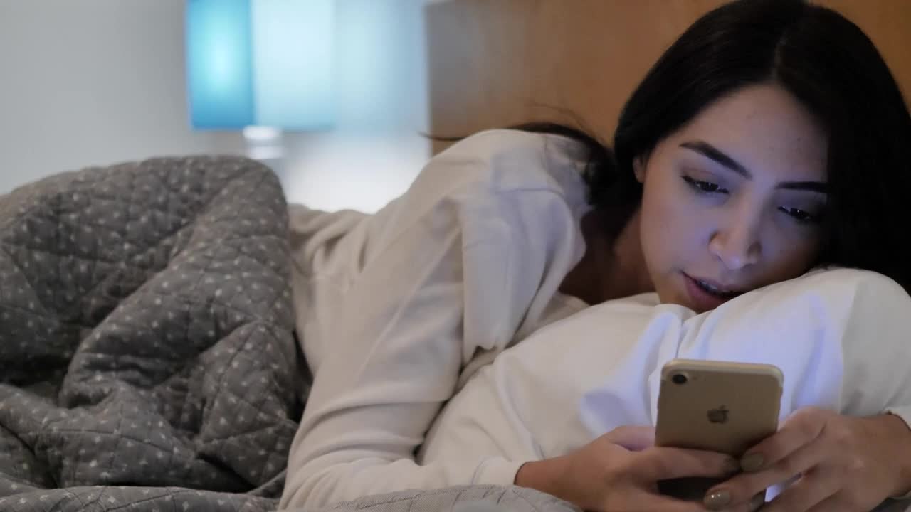 Stock Video Girl Lying Down Chatting On Her Cell Phone Before Sleeping Live Wallpaper For PC