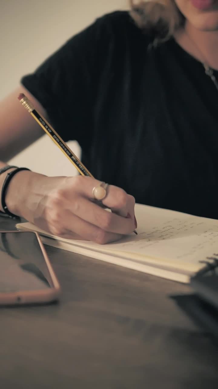 Stock Video Girl In Glasses Writing With Pencil On A Notepad Live Wallpaper For PC