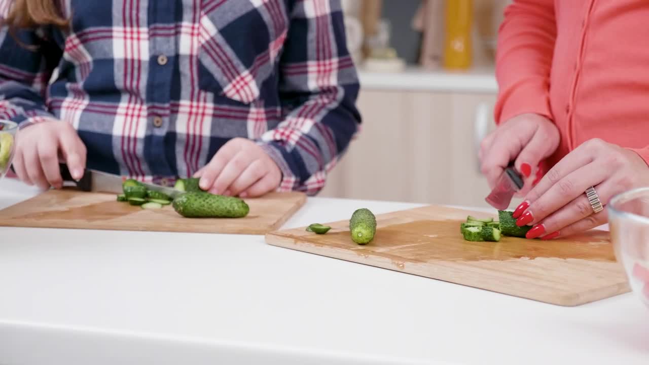 Stock Video Girl Helps Mom Chop Vegetables In Kitchen Live Wallpaper For PC
