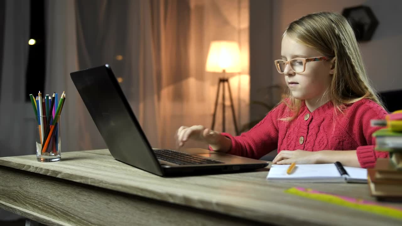 Stock Video Girl Doing Her Homework At A Desk With A Computer Live Wallpaper For PC