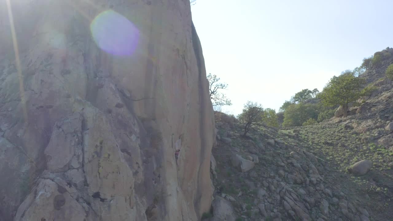 Stock Video Girl Descending A Rocky Hill With The Help Of A Live Wallpaper For PC