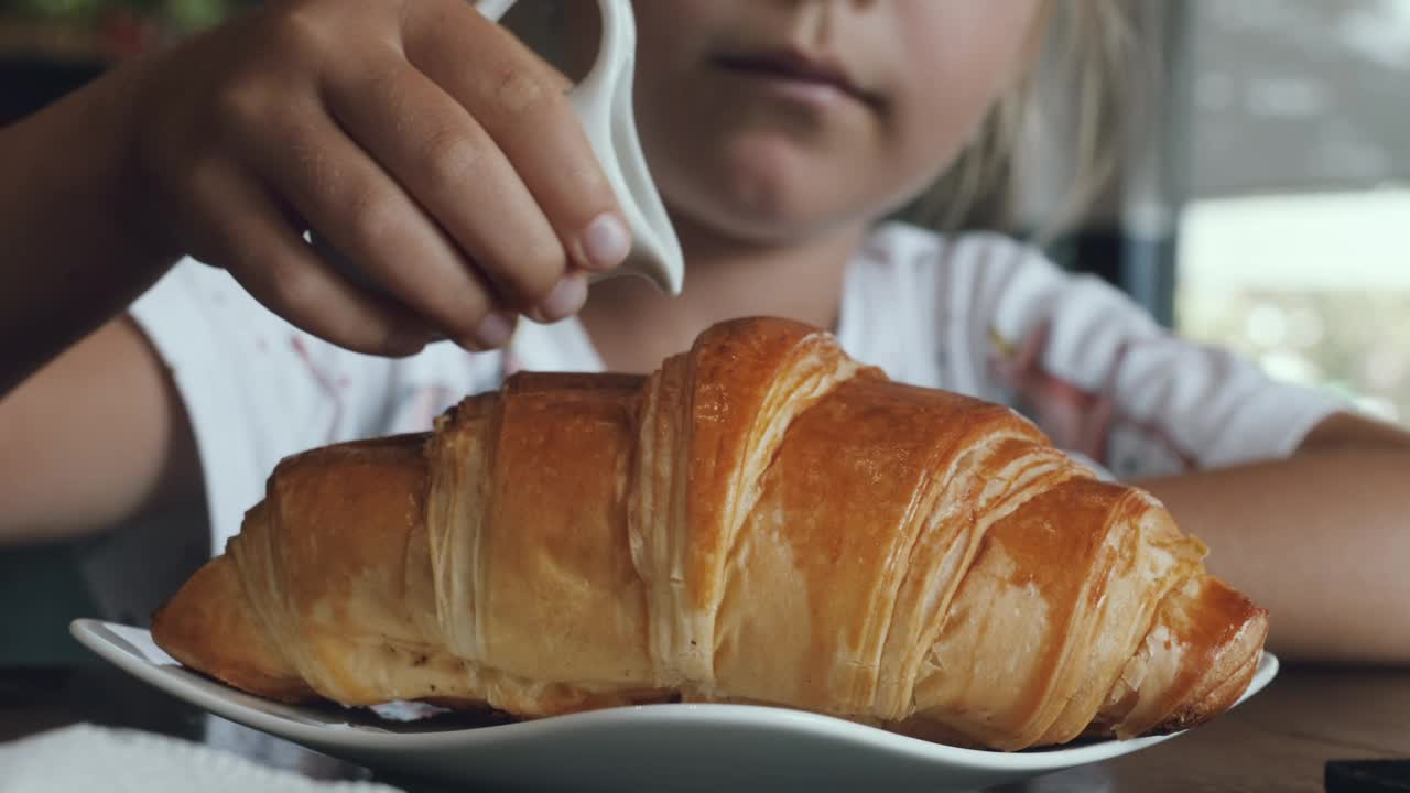 Stock Video Girl Adding Sweet Milk On A Croissant Live Wallpaper For PC