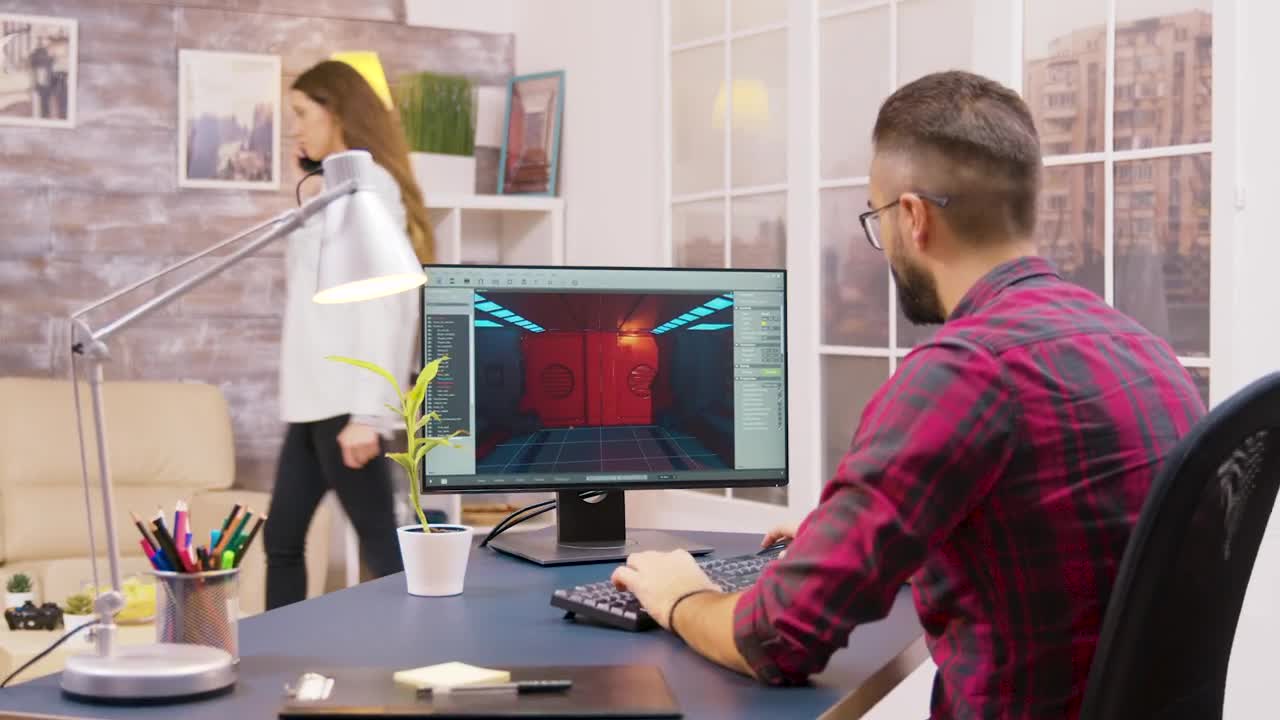 Stock Video Game Developer Working From Home Viewed From Behind Live Wallpaper For PC