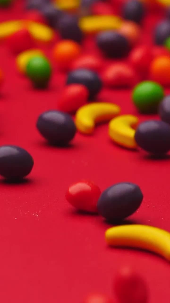 Stock Video Fruit Shaped Sweets Rolling On A Red Surface Live Wallpaper For PC