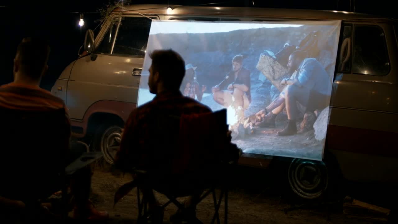 Stock Video Friends Watching A Movie Projected On The Van Live Wallpaper For PC