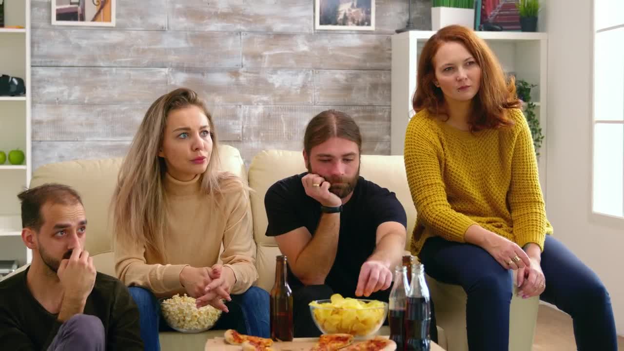 Stock Video Friends Show Fear While Watching Movie On Sofa With Pizza Live Wallpaper For PC