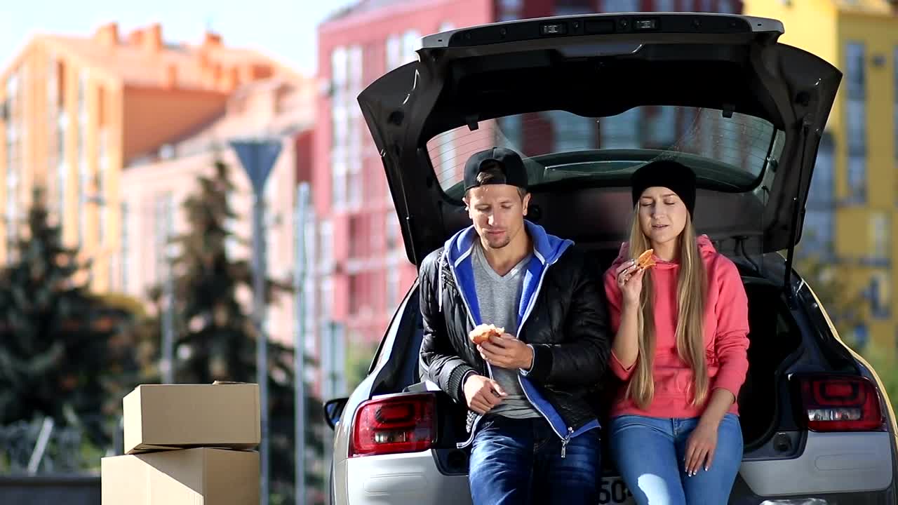Stock Video Friends Laughing And Eating Sitting In A Car Trunk Live Wallpaper For PC