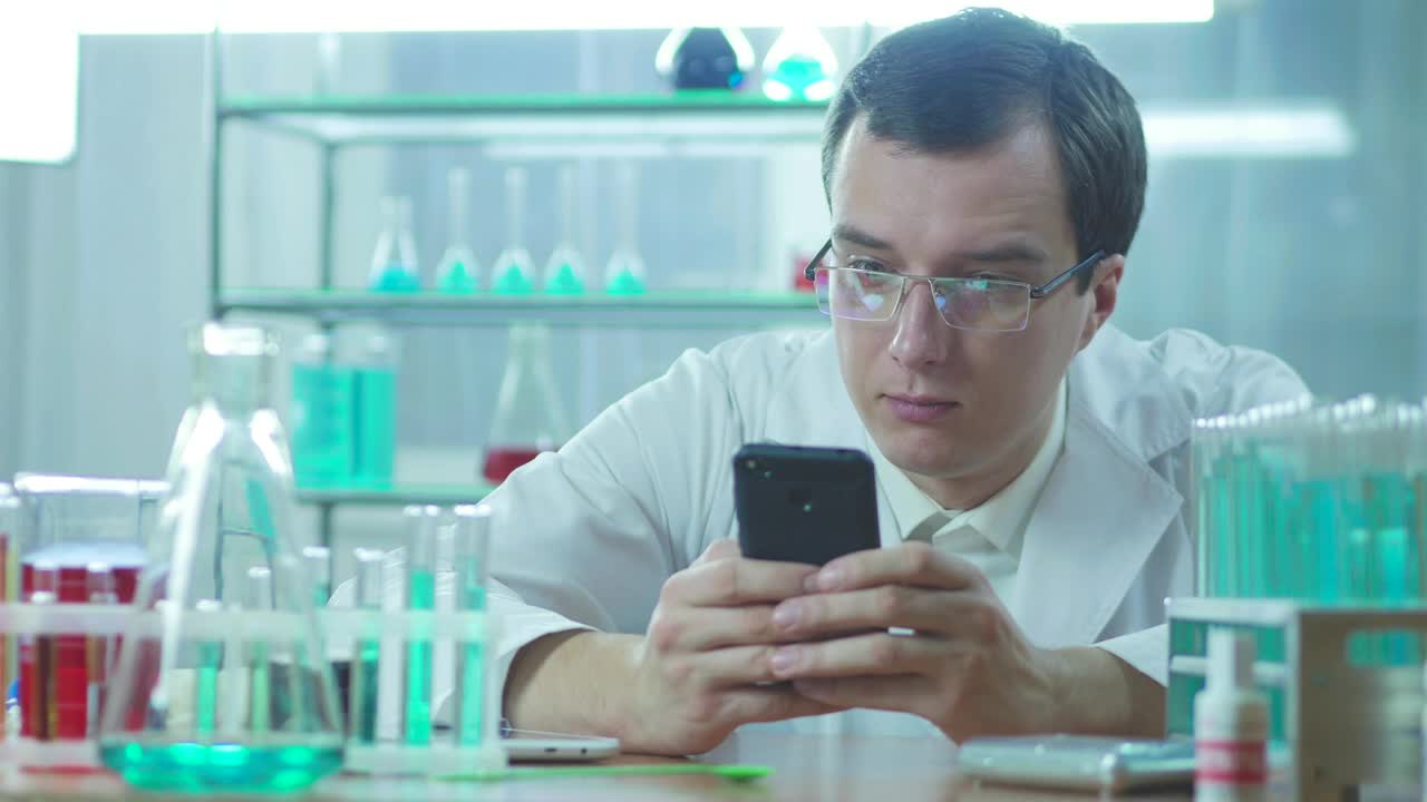 Stock Video Laboratory Scientist Looking At The Phone Animated Wallpaper