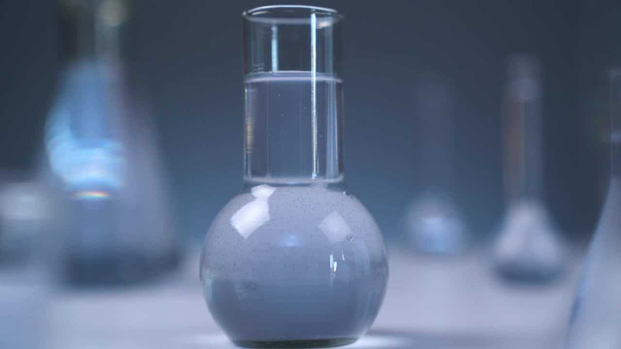 Stock Video Laboratory Flasks With Gray Liquid Animated Wallpaper