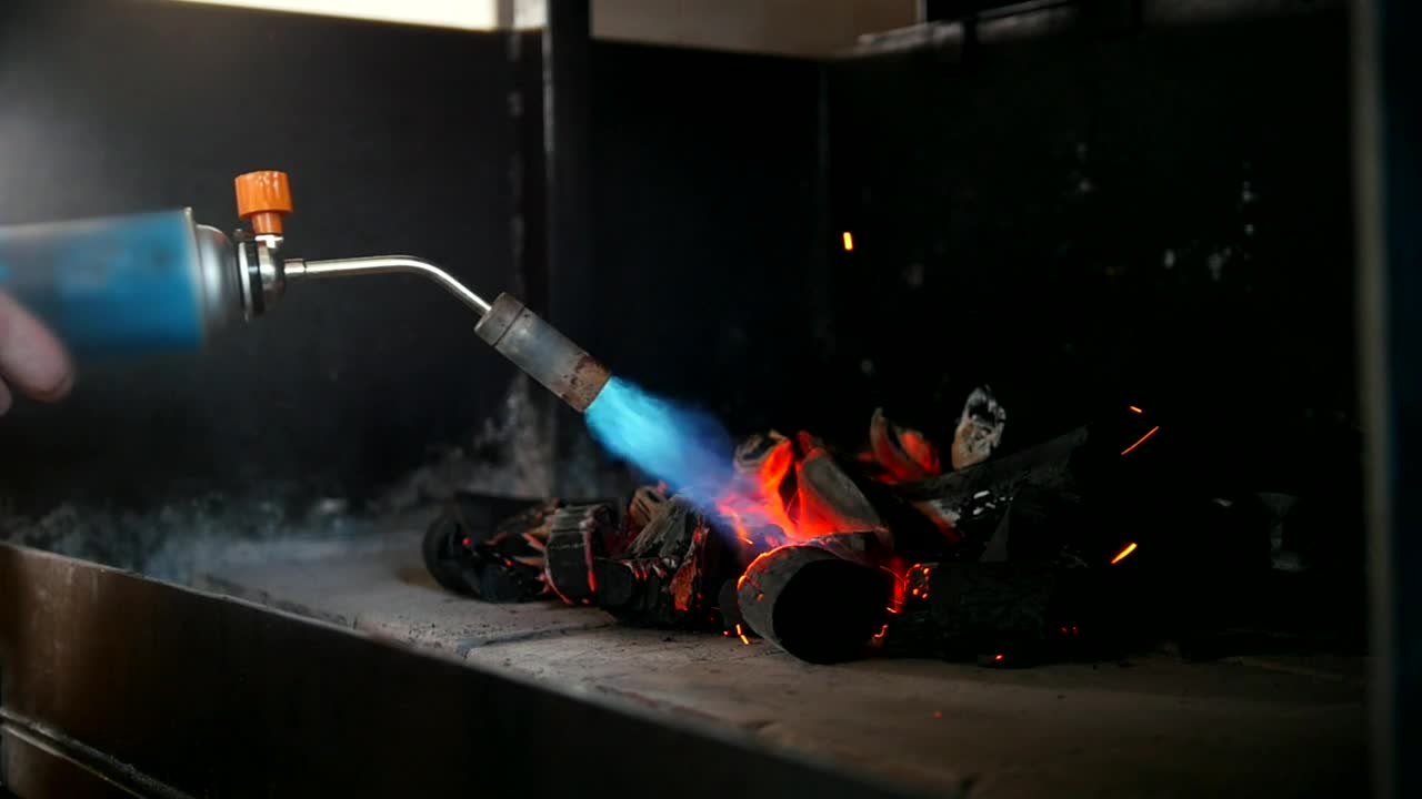 Stock Video Kindling Charcoal Using A Gas Burner Animated Wallpaper