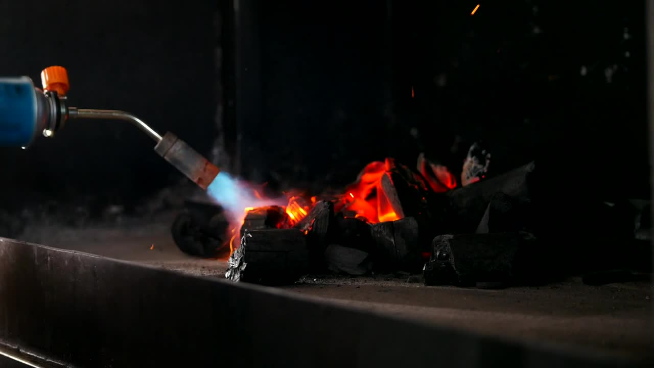 Stock Video Kindling Charcoal For The Grill With A Gas Burner Animated Wallpaper