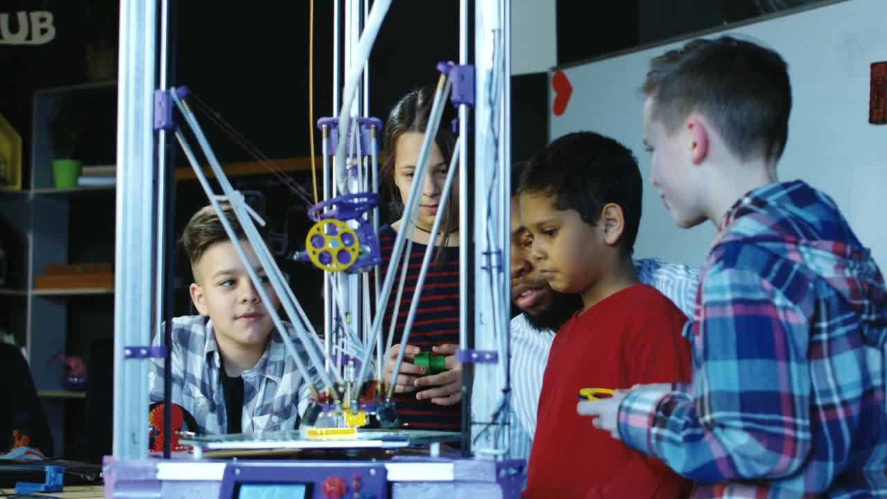 Stock Video Kids Watching A D Printer At School Animated Wallpaper