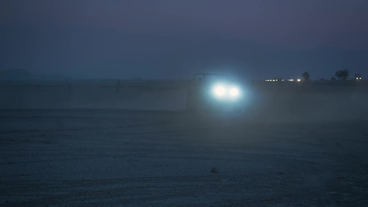 Stock Video Jeep With Headlights On In A Desert At Night Animated Wallpaper