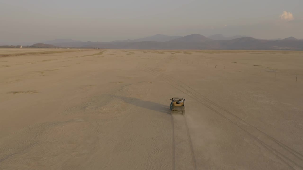 Stock Video Jeep Truck Traveling Through A Desert Seen From The Air Animated Wallpaper