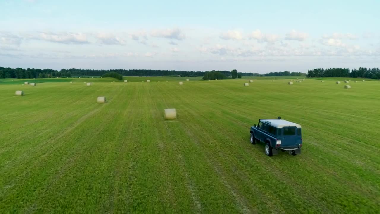 Stock Video Jeep Driving Through The Green Fields Animated Wallpaper