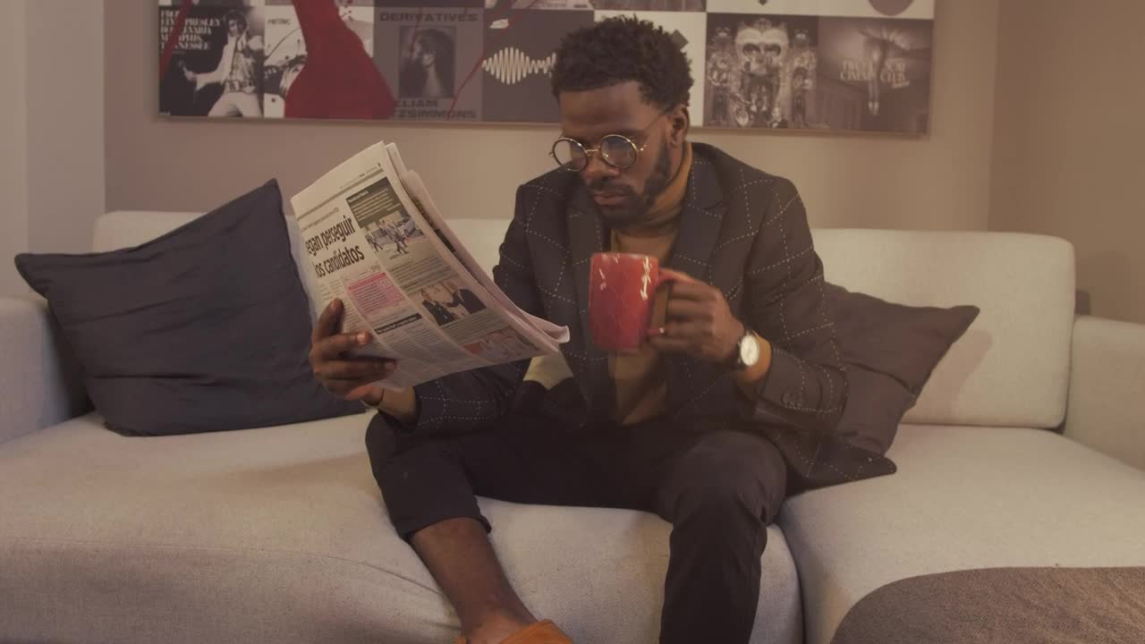 Stock Video Intellectual Man Reading The Newspaper With A Cup Of Coffee Animated Wallpaper
