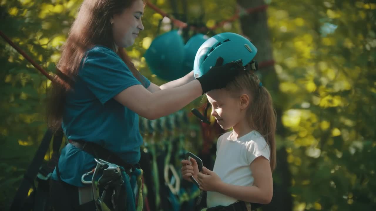 Stock Video Instructor Putting A Protective Helmet On A Little Girl Animated Wallpaper