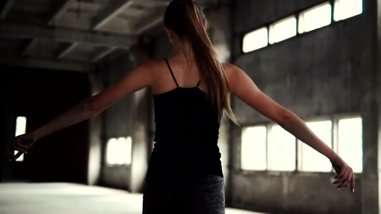 Stock Video Inspired Woman Dances In Warehouse Animated Wallpaper