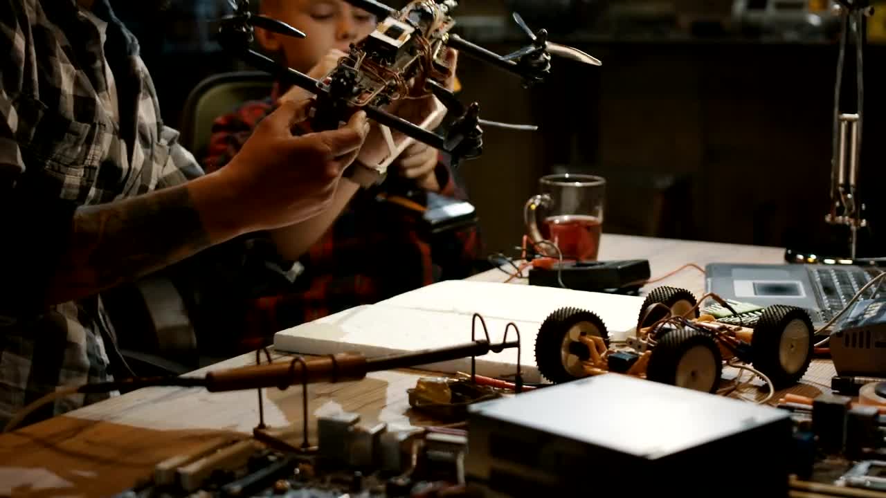 Stock Video Inspecting A Drone In A Workshop Animated Wallpaper