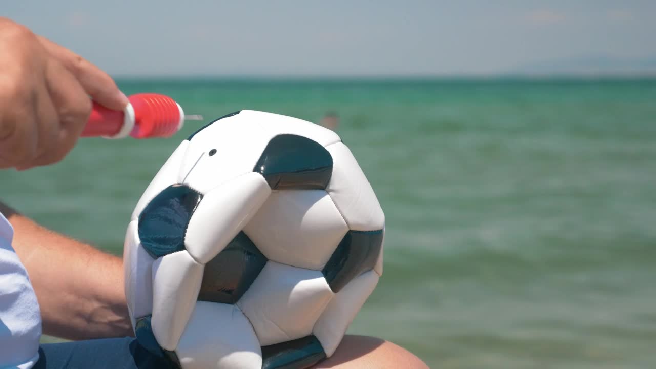 Stock Video Inflating A Ball For A Beach Game Animated Wallpaper
