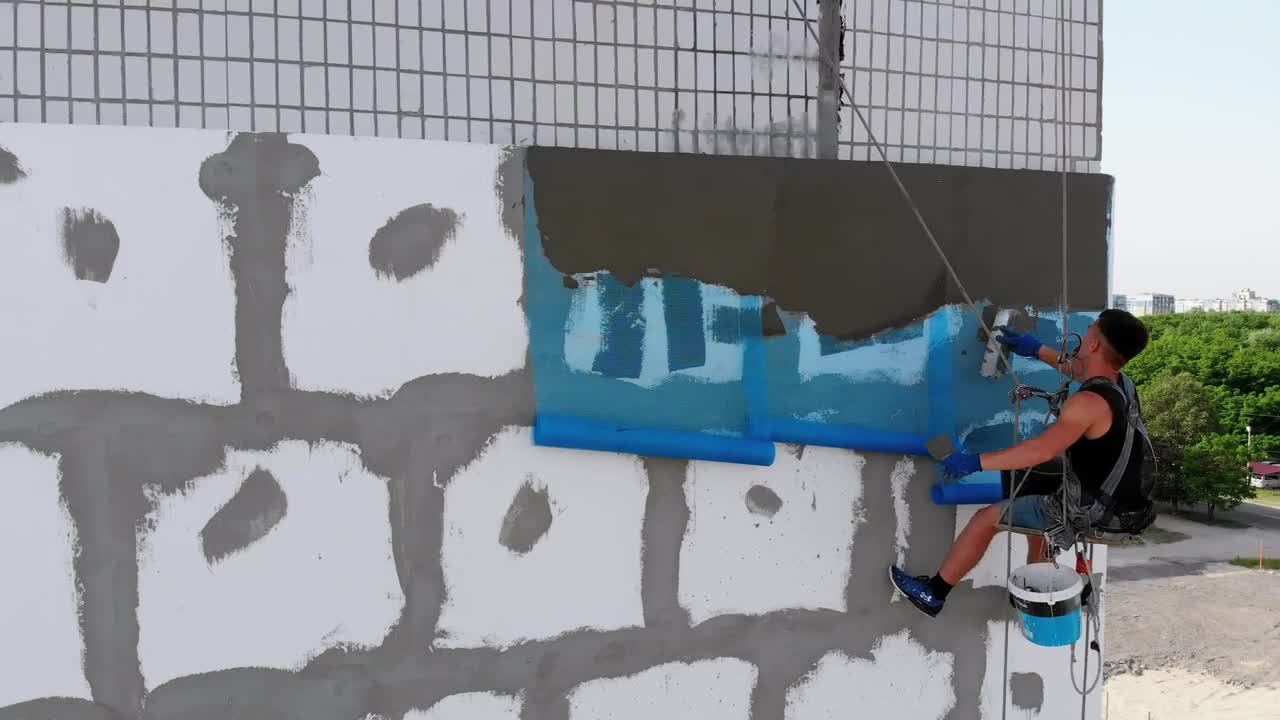 Stock Video Industrial Climber Putting Cement To A Wall Animated Wallpaper