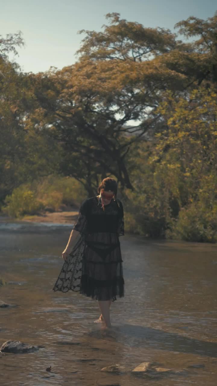 Stock Video Indie Fashion Girl Walking On A River Animated Wallpaper