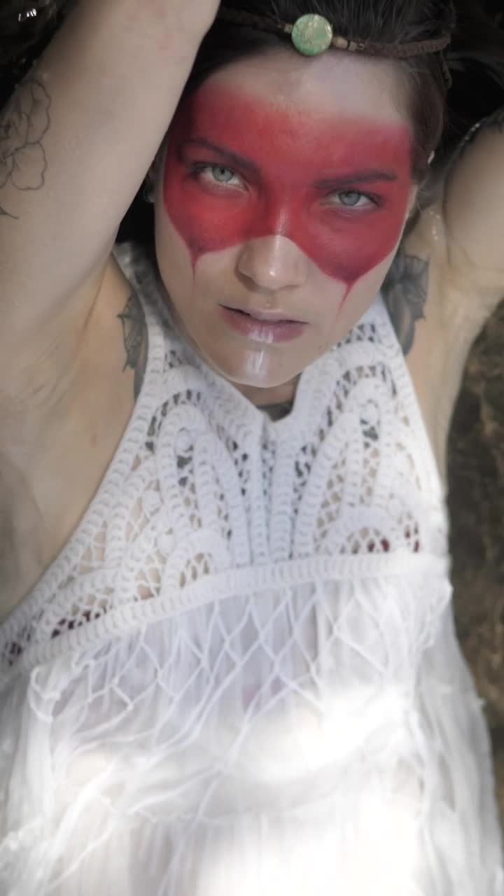 Stock Video Indie Fashion Girl Laying Down On A River Animated Wallpaper