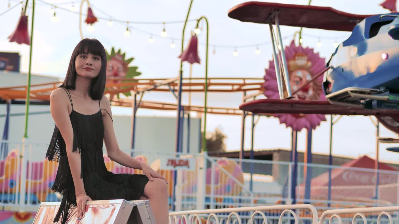 Stock Video Immobile Woman Sitting Next To A Mechanical Game Animated Wallpaper