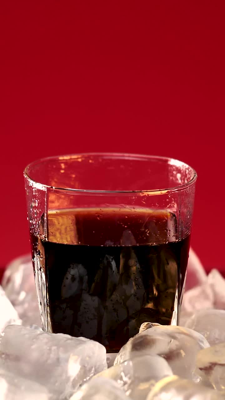 Stock Video Ice Falling Into A Glass With Soda Animated Wallpaper