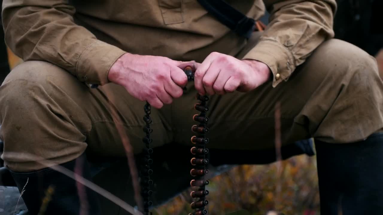 Stock Video Hunter Loading A Belt Of Bullets In A Nearby Shot Animated Wallpaper