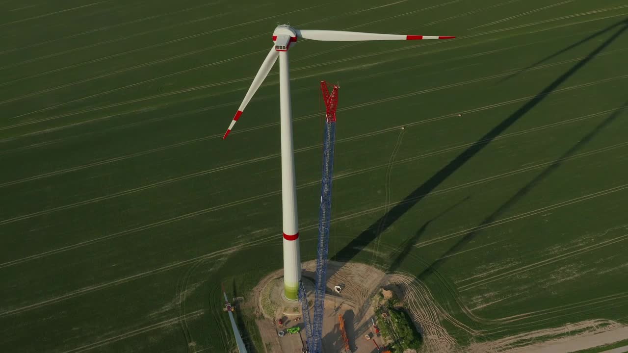 Stock Video Huge Wind Turbine Under Repair Seen From The Air Animated Wallpaper