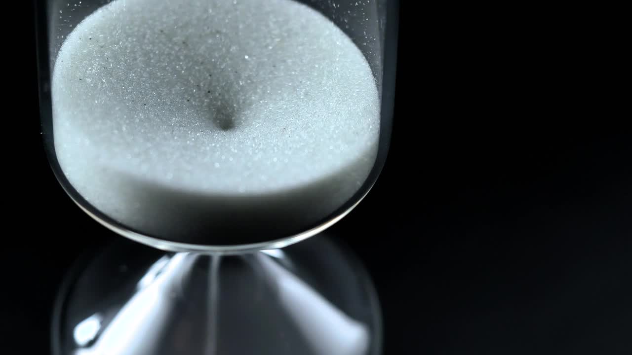 Stock Video Hourglass Close Up On A Black Background Seen From Above Animated Wallpaper