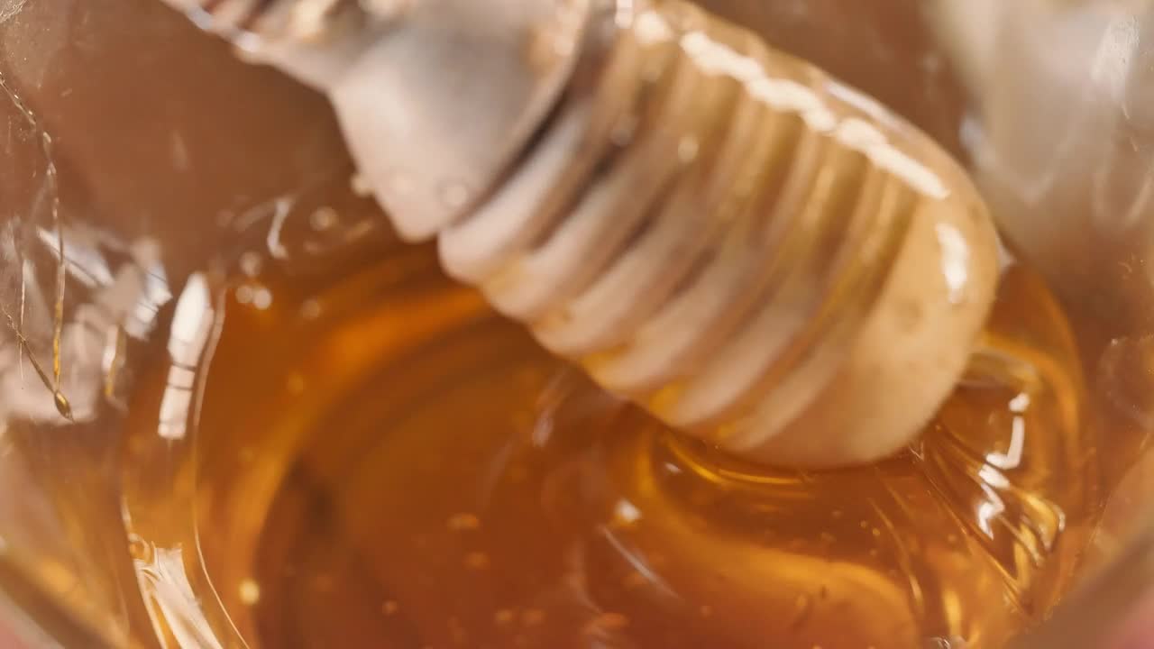 Stock Video Honey Dipper Coming Out Of A Glass Vase With Honey Animated Wallpaper