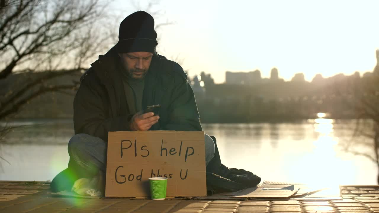 Stock Video Homeless Man With A Smartphone Animated Wallpaper