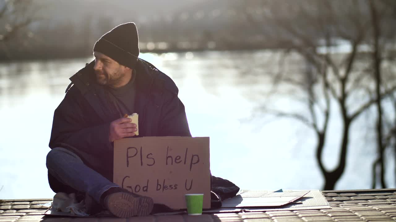 Stock Video Homeless Man Eating And Begging On The Street Animated Wallpaper